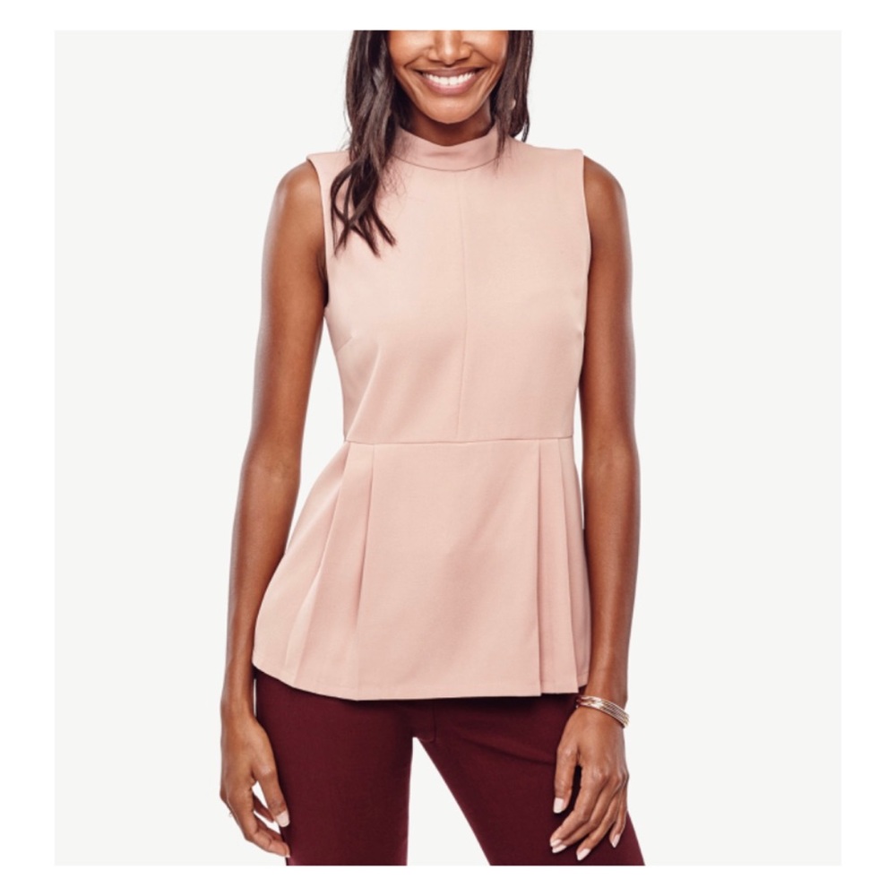 Woman’s light pink mock neck peplum top